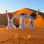 Viajeros disfrutando de las dunas en el viaje 3 dias desde fez a Marrakech